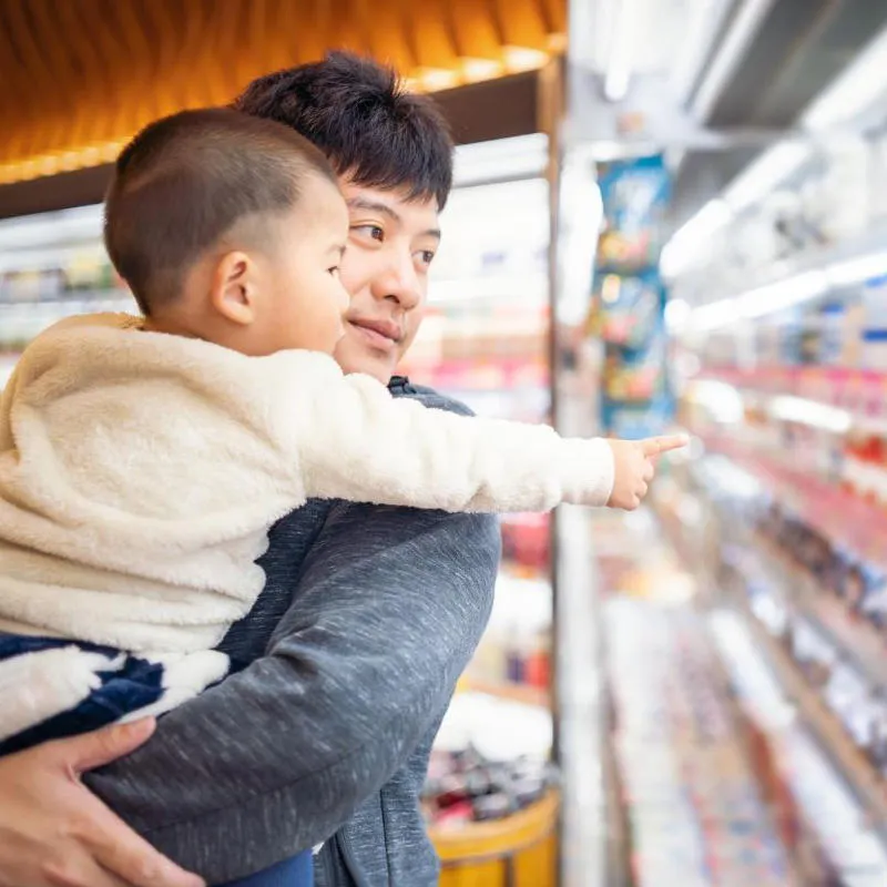 Man and child in supermarket isle